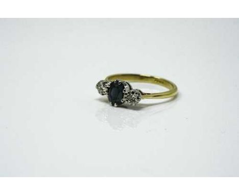 An 18ct yellow gold three stone diamond and sapphire ring, approximately 0.4ct, size O/P.