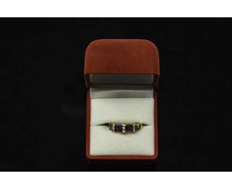 A 14ct gold ruby and diamond  set ring, size N/O, the twelve round diamonds approximately 0.24ct.