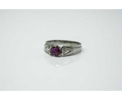 An 18ct white gold ruby and diamond ring, approximately 0.5ct, size K.