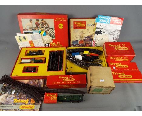 Triang - A vintage suitcase containing a mainly boxed collection of Triang OO gauge model railway items, and ephemera. Lot in