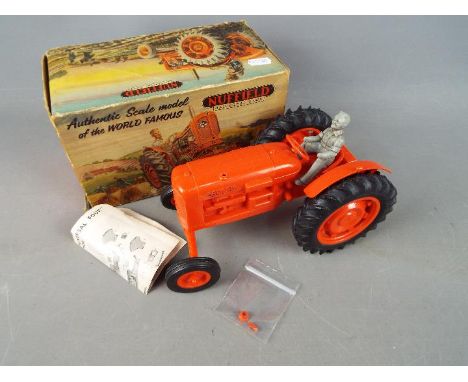 Raphael Lipkin - A boxed Raphael Lipkin 'Nuffield Universal Four' plastic tractor. This rare plastic tractor in red with rubb