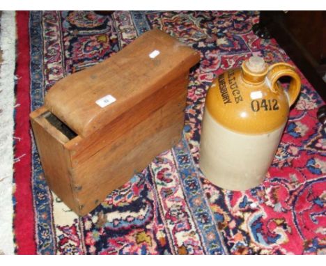 An old wooden caulker's stool with sliding top, together with an old stoneware bottle