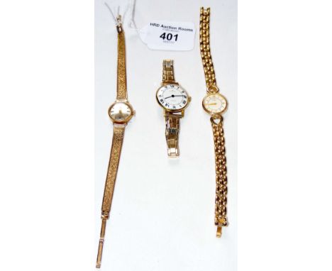 A lady's 9ct gold Tissot watch and strap, together with two other ladies' wrist watches