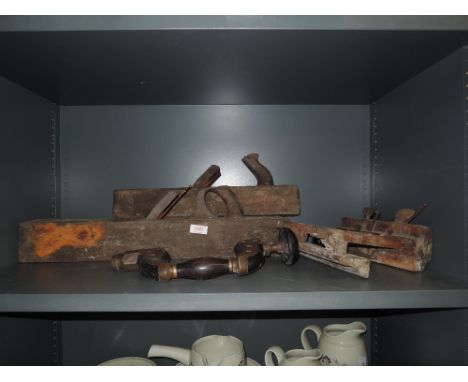 A selection of carpentry tools including brass brace