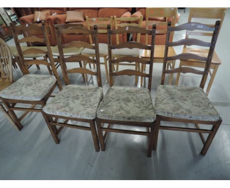 A set of four Ercol ladder back chairs, mid stain