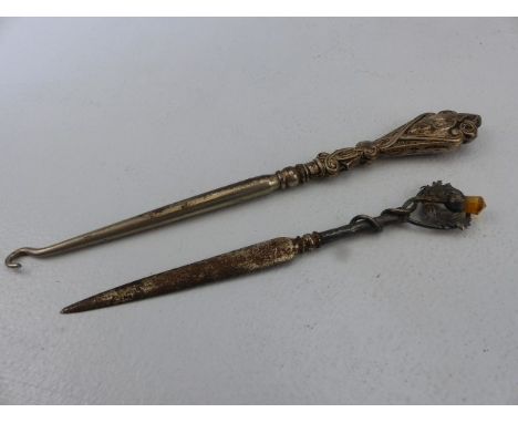 Hallmarked silver topped button hook, and a hallmarked silver paperknife set with the scottish thistle and amber coloured sto