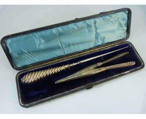 Cased button hook and glove stretcher both with silver hallmarked handles