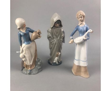 NAO FIGURE OF A BOY AND A PUPPY, 27cm high, along with two ceramic figures of females (3)