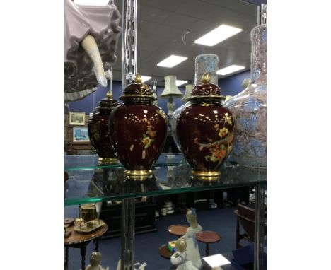 PAIR OF CARLTONWARE LIDDED JARS, each decorated with exotic birds in coloured enamels and gilt, 18cm high