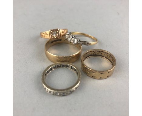 THREE STONE RING, marked with 18ct, along with a fifteen carat gold ring, two nine carat gold wedding bands and an eternity r