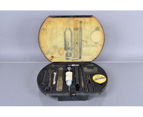 A vintage Jaguar MkII tool kit, to include spanners, an adjustable spanner, hand pump, spark plug and more, all within fitted