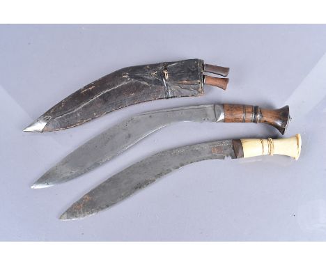 A Middle Eastern Kukri, stamped El. Alamein, to the blade, complete with the scabbard and two skinning knives, plus a bone ha