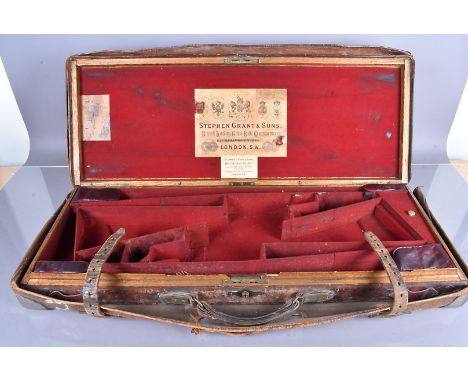 A vintage Stephen Grant &amp; Sons gun case, with burgundy fitted interior, original labels to lid, the top of the leather bo