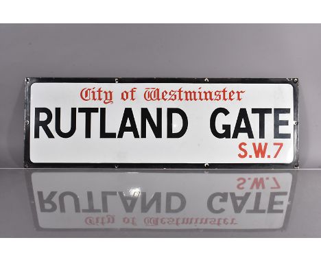 A City of Westminster enamel road sign, for Rutland Gate, S.W.7, black and red lettering on white background, with black bord