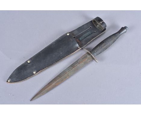 A Post War Fairbairn Sykes Fighting dagger, with crossed keys and D* to the grip, complete with WD stamped scabbard (1) 