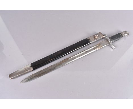 A British 1875 Pattern Sawback bayonet, with King's head and crown stamped to the blade, blade 46cm long, black plastic grip 