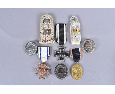 A WWI Iron Cross, marked KO to the hanger loop, together with three Wound badges, a WWI Veterans medal, two epaulettes and a 