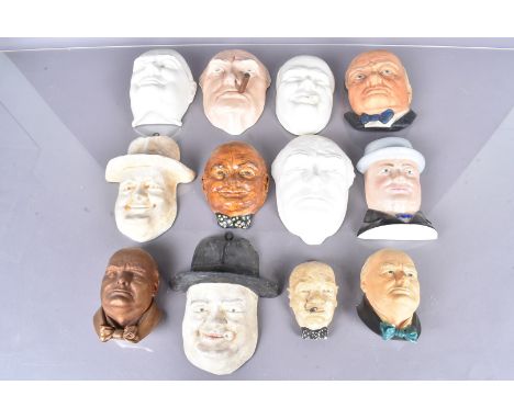 A group of twelve wall hanging portrait masks of Winston Churchill, to include a Minton example modelled by Eric Owen, Royal 