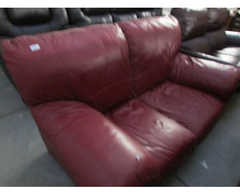 A red leather 2 seat sofa