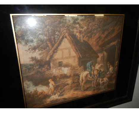 A framed & glazed lithograph of an old country Cottage
