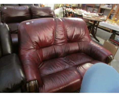 A 2 seat red leather sofa