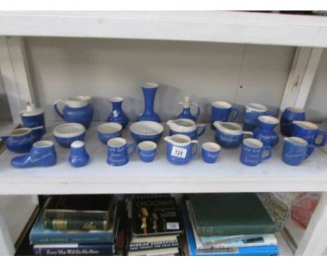 A shelf of souvenir pottery