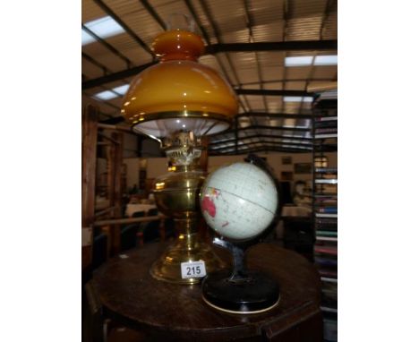 An oil lamp and a tin plate globe