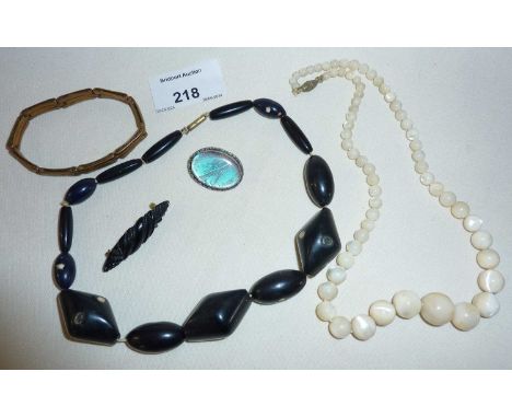 Old Balamuti mother of pearl bead necklace, silver butterfly wing brooch, Whitby Jet? brooch, etc.