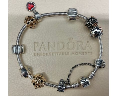 Pandora Sterling Silver Charm BraceletThe bracelet includes two 14ct Gold Charms, a "MUM" charm, a heart shape charm with CZ 