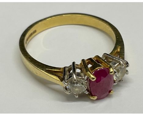 18ct Gold Synthetic Ruby and Diamond Ring, the ring is set with an oval brilliant cut synthetic pink ruby that measures appro