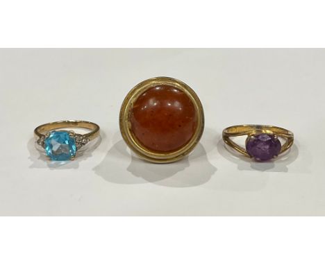 A selection of rings to include; a 9ct yellow gold 2.78ct Topaz and diamond ring, a silver gilt purple paste stone ring and a