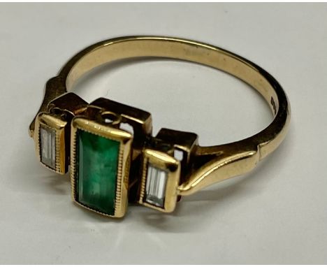 9ct Gold Emerald and Diamond Trilogy RingThe ring is set with a rectangular step cut Emerald that measures approx. 0.60ct and