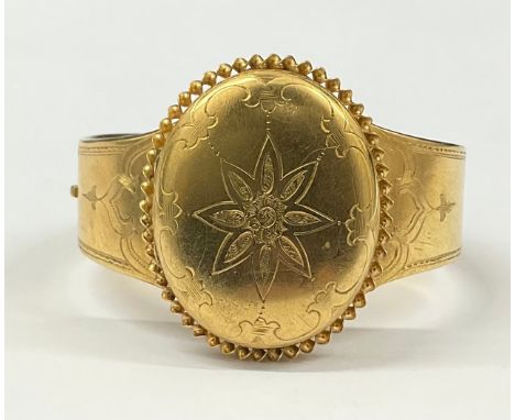 Victorian Tested 18ct Gold Victorian Half Hinged BangleThe bangle has a photo compartment with etched flower decoration which
