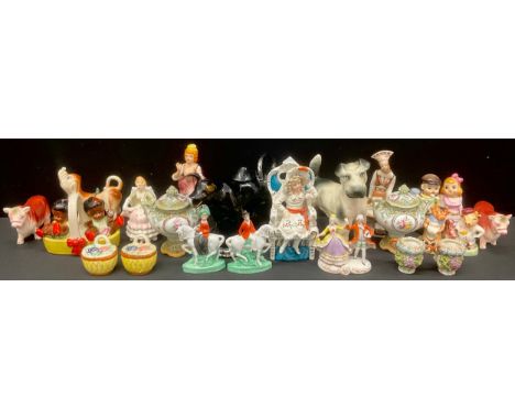 A novelty condiment set as children and play, others, Cows etc, tape measures as seated lady's, Cow creamer, pair of small co