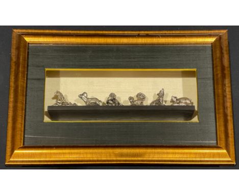 A collection of six Burmese silver plated figurines, each representing signs of the Zodiac, cased for display, 39cm x 59cm ov