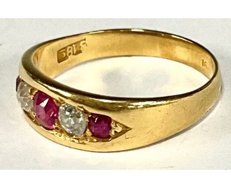 A diamond and ruby alternate set five stone ring, three pink red rubies divided by old cut diamonds, yellow metal shank, stam