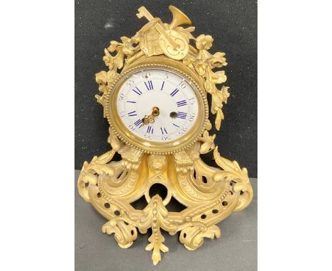 A 19th century French ormolu mantel clock case with partial movement, 10.5cm convex enamel dial inscribed with Roman and subs