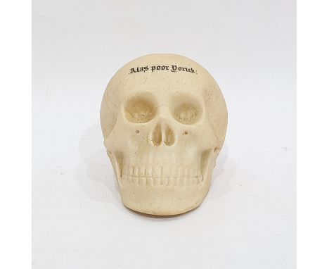 Porcelain model of a skull by W H Goss, of realistic colouring, inscribed 'Alas Poor Yorick', 8cm high 
