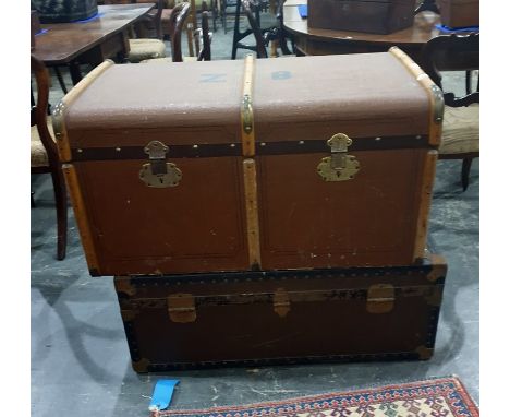 Large wood bound canvas travelling trunk and a tin travelling trunk carrying shipping labels (2)