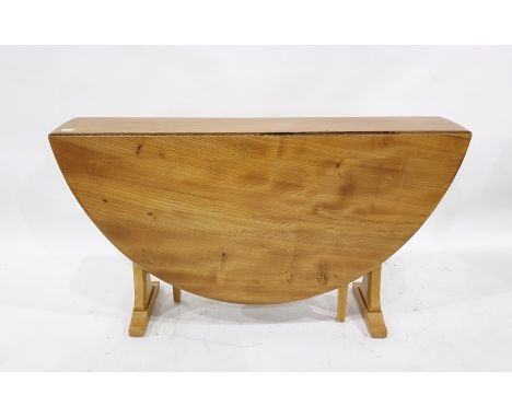 Light elm Ercol drop-leaf dining table with beech pedestal end supports, the top 127cm x 139cm extended 