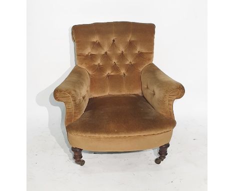 Late Victorian low armchair in a brown button-back upholstery, turned front legs to brown china castors 