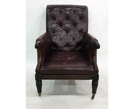 19th century red leather button-back and mahogany-framed club armchair on turned and carved tapering front legs, to brass cap