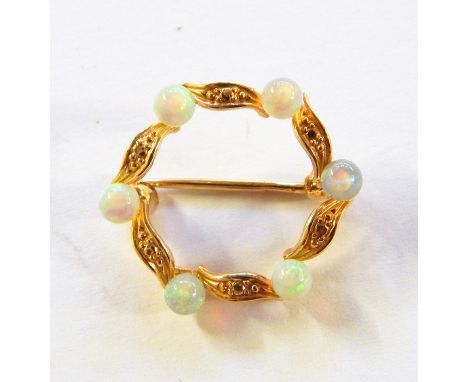 Gold-coloured metal and opal circlet brooch, foliate design set with six spherical opals 