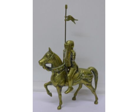 A solid brass model of a knight on horseback