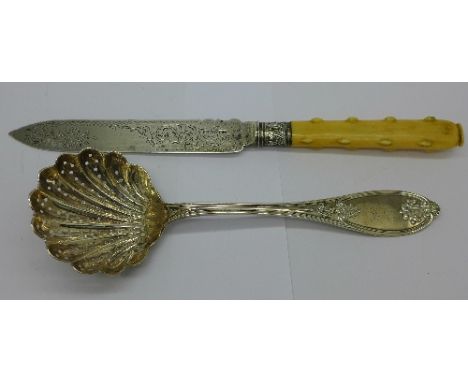 A silver bladed knife and a white metal sifter spoon marked J. Rudd and with inscription dated 1856