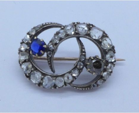 An old cut diamond set brooch, also set with a cognac diamond and a sapphire, width 26mm