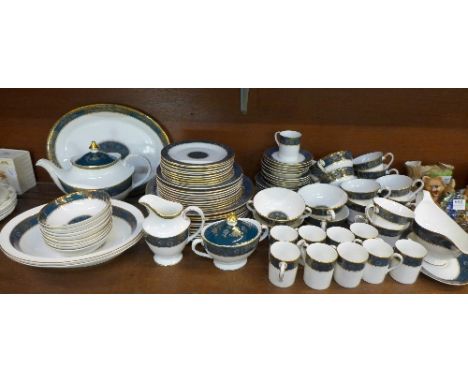 A collection of Royal Doulton Carlyle dinnerware, serving plates, dishes, bowls, coffee and tea cups, saucers, cream, teapot,