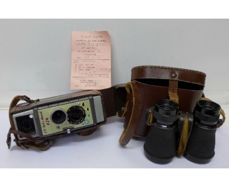A Bell & Howell 624 8mm cine camera and a pair of binoculars