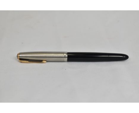 A Parker 51 button fountain pen in black with lustraloy cap having gold clip bearing blue diamond. In good condition