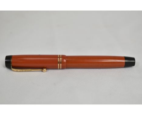 A Parker Duofold button fill fountain pen in coral red with two bands to cap having Parker Duofold nib. In very good conditio